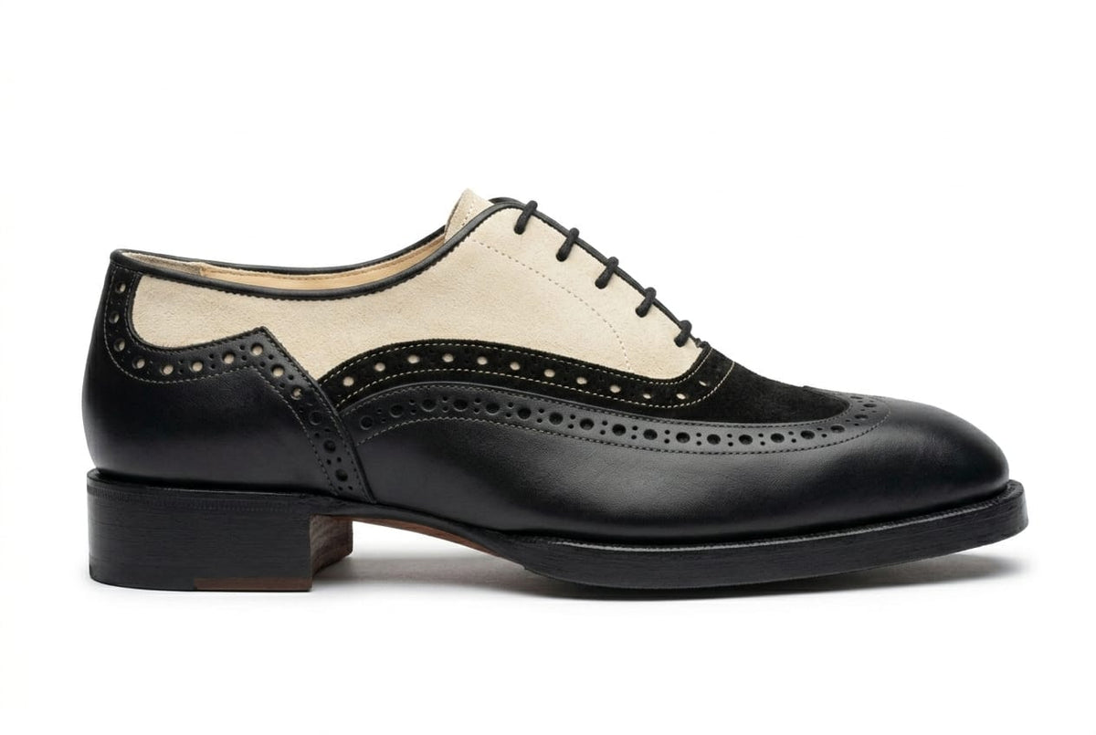 Black and white leather shoe on a white background